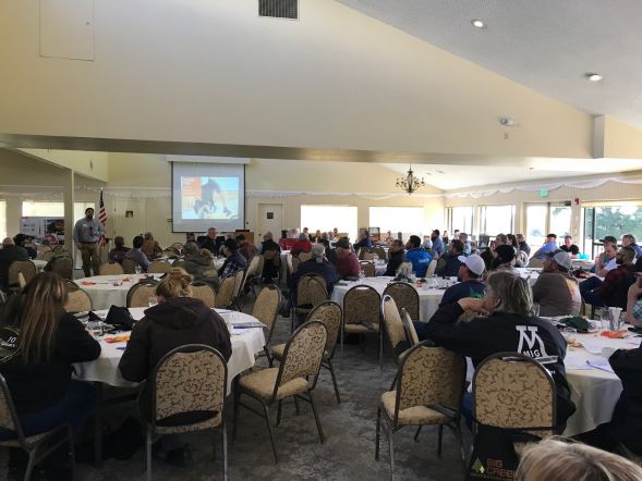 Large group around tables at Contractor's conference.