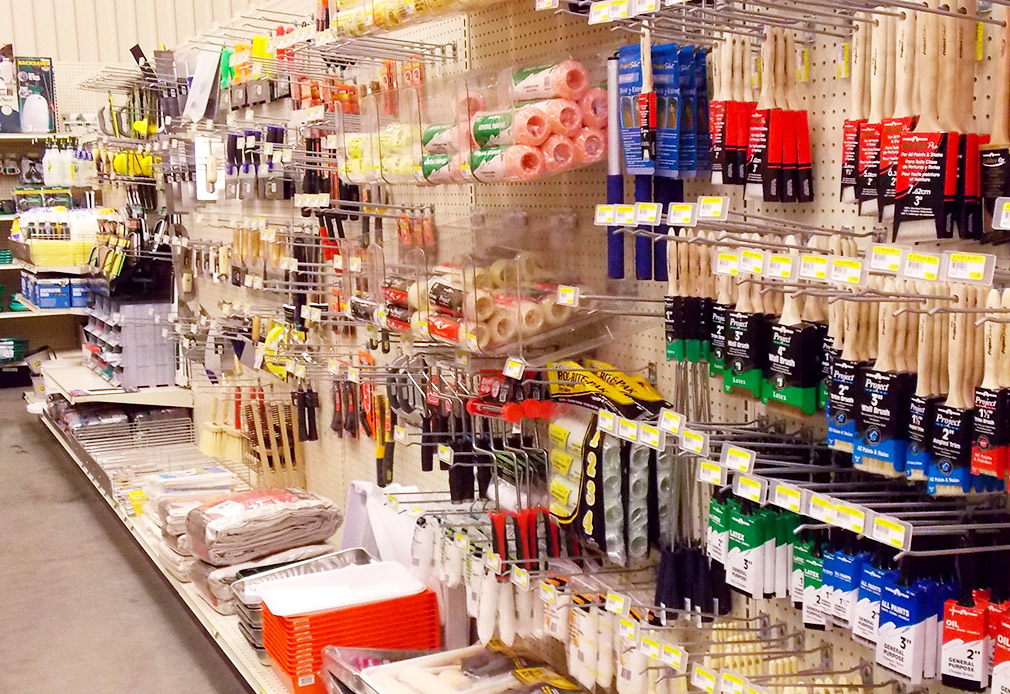 Retail shelves with paints and primer on them.