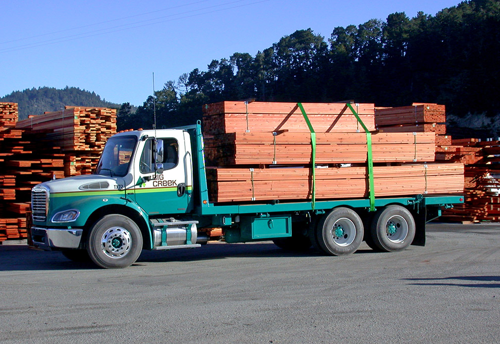 Delivery truck with stacked redwood planks