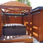 View of hot tub with pergola.