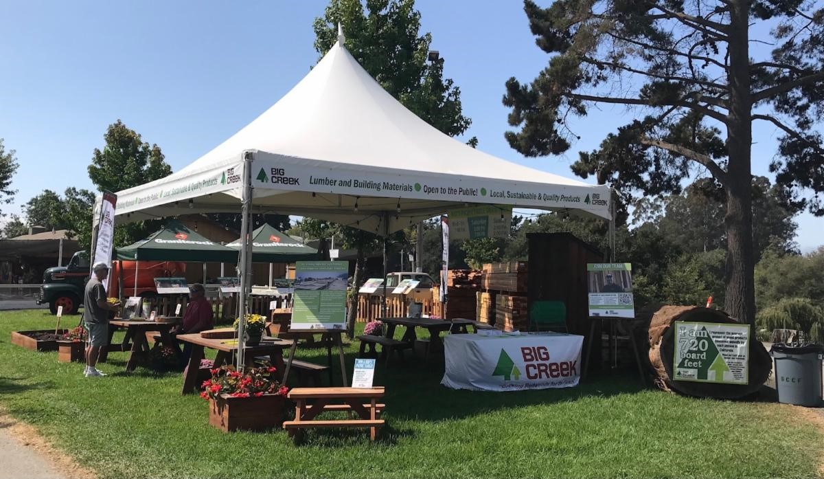 Tent over a fair booth with a grassy area