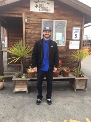 Man standing in front of shed