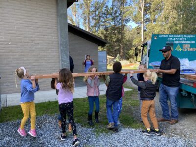 Kids unloading a board from a truck