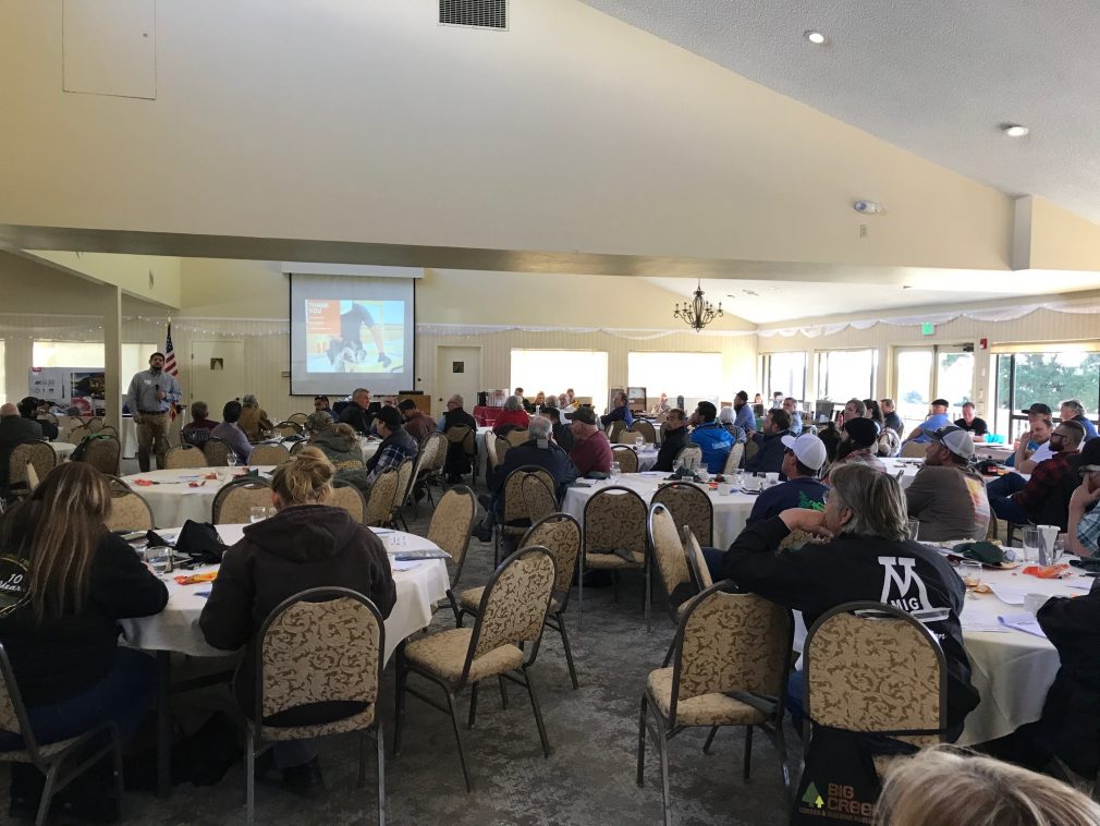 Room full of contractor conference attendees listening to a presentation