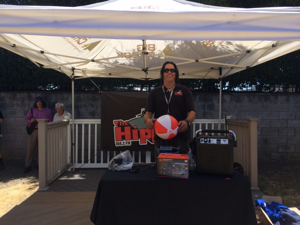 man with beach ball at booth at customer event