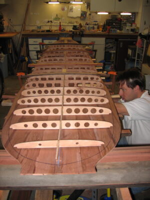 Man building a redwood surfboard