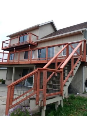 Redwood deck on a house with stairs and a redwood railing