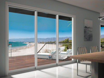 Windows looking out onto a deck and the beach 