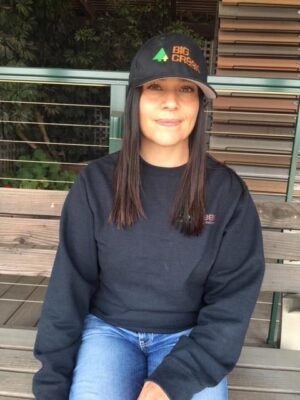 Woman sitting with hat on and sweatshirt