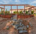 Outdoor octagonal herb garden with stone steps.