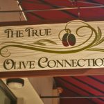 redwood sign for The True Olive Connection.