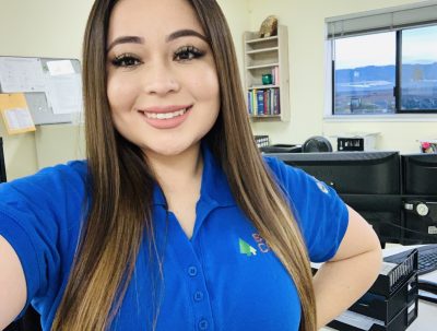 Woman smiling at camera in a blue shirt